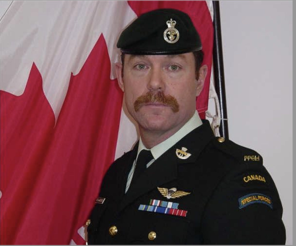 Maj. Paeta Hess-von Kruedener in front of Canadian flag